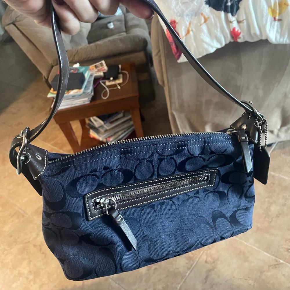 Navy blue coach shoulder bag.
